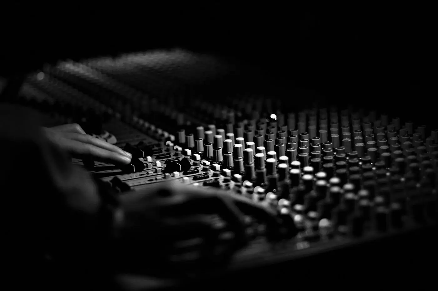 Hands on a mixing console