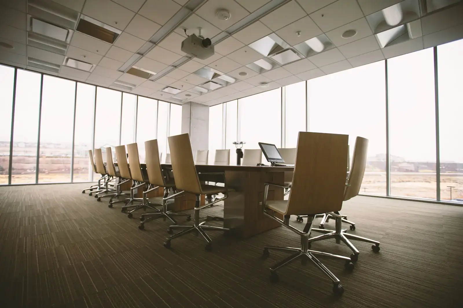 Conference table beside a glass wall