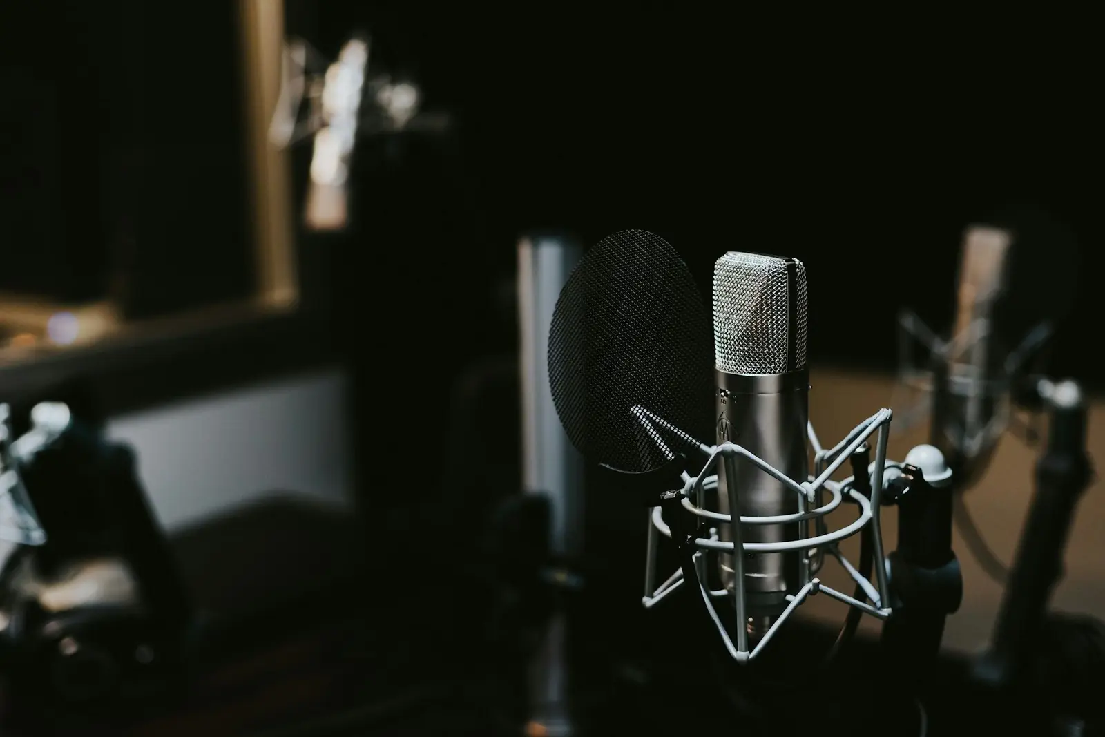 A condenser microphone in a dark recording room